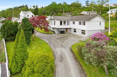 an aerial view of a white house with a driveway at Fjord studio in Sunde