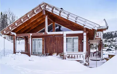 a log cabin in the snow at Cozy Home In Rjukan With Kitchen in Rjukan