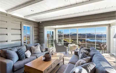 a living room with a couch and a table at Beautiful Home In Rauland With Sauna in Rauland