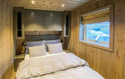 a bed in a small room with a window at Awesome Home In Rauland With Wifi in Rauland