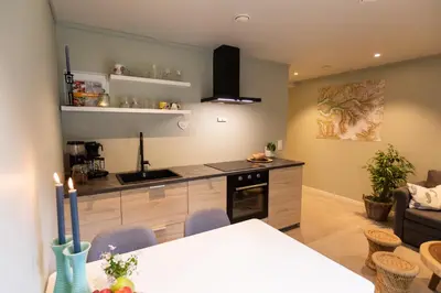 a kitchen and living room with a table and chairs at Lodgen Stryn in Stryn