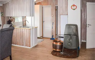 a kitchen with a stove in the middle of a room at 3 Bedroom Awesome Home In Vikersund in Vikersund