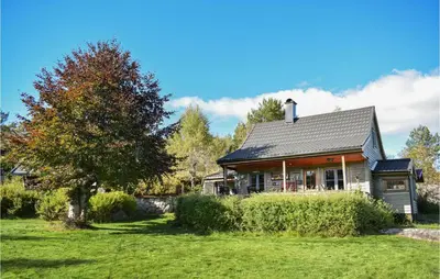 a house on a grassy yard with a tree at Gorgeous Home In Aksdal With Kitchen in Aksdal