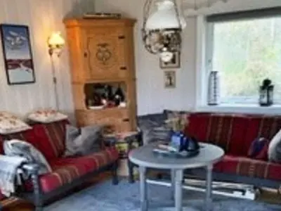 a living room with two couches and a table at 4 person holiday home in Svelgen-By Traum in Sørgulen