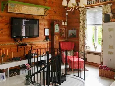 a living room with a television and red chairs at 8 person holiday home in Bruvik-By Traum in Bruvik