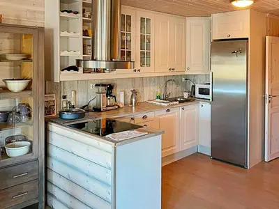 a kitchen with white cabinets and a stainless steel refrigerator at 10 person holiday home in Rauland-By Traum in Rauland