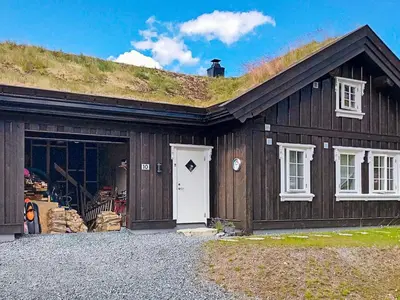 a barn with a grass roof on top of it at 10 person holiday home in Rauland-By Traum in Rauland