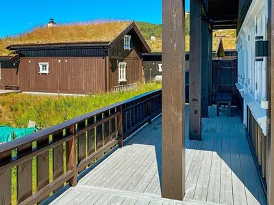 a porch of a house with a wooden railing at 10 person holiday home in Rauland-By Traum in Rauland