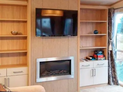 a living room with a tv and a fireplace at 6 person holiday home in Tansøy-By Traum in Tansøy