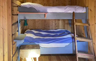 two bunk beds in a wooden cabin at 3 Bedroom Nice Home In Kvam in Kvam