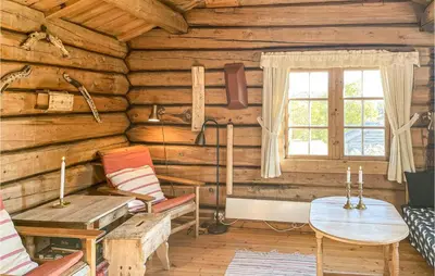 a room in a log cabin with a table and chairs at 3 Bedroom Nice Home In Kvam in Kvam