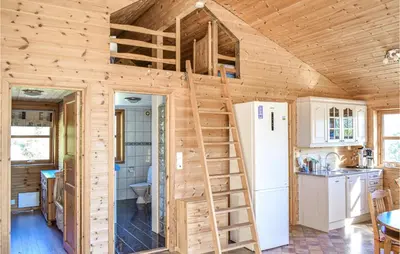 a tiny house with a staircase in a kitchen at Nice Home In Os With House Sea View in Oma