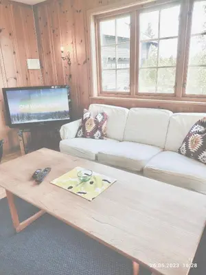 a living room with a white couch and a coffee table at Nordgards Hagen in Lillehammer
