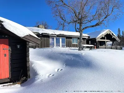 a pile of snow in front of a house at Vasethytta - cabin with a lovely view in Ron