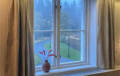 a window with a vase sitting on a window sill at Stunning Apartment In Lillehammer in Lillehammer