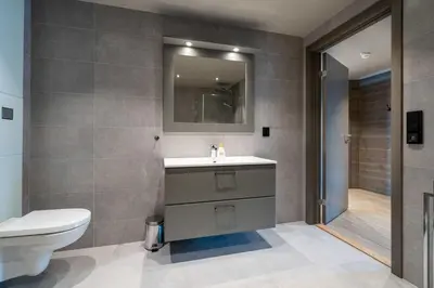 a bathroom with a sink and a toilet and a mirror at Riddertunet apartment 101 in Beitostøl