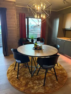a dining room with a round table and chairs at Riddertunet apartment 101 in Beitostøl