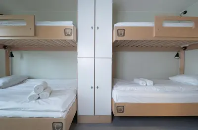 two bunk beds in a room with towels on them at Rumi Hostel in Trondheim
