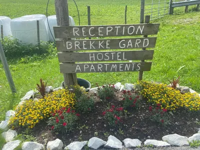 a sign in a flower bed in a garden at Brekke Apartments in Flåm