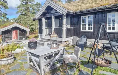 a table and chairs in front of a house at 4 Bedroom Pet Friendly Home In Eggedal in Eggedal