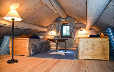 a bedroom with two beds and a table in a cabin at 4 Bedroom Pet Friendly Home In Eggedal in Eggedal