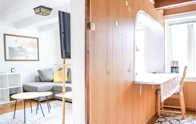 a living room with a couch and a table at 2 Bedroom Cozy Home In Vallavik in Kaland