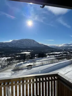 a view of a snow covered field with a bench at Privat apartment with beautiful view and two bedrooms in Oppdal