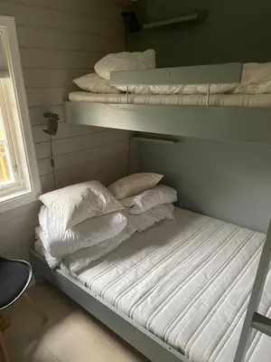 a room with three bunk beds and a window at Privat apartment with beautiful view and two bedrooms in Oppdal