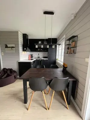 a kitchen with a wooden table and chairs in a room at Privat apartment with beautiful view and two bedrooms in Oppdal