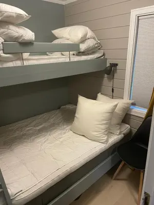 a bedroom with two bunk beds with white pillows at Privat apartment with beautiful view and two bedrooms in Oppdal