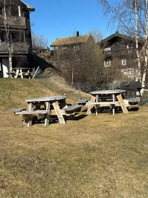 a group of picnic tables in a field at Privat apartment with beautiful view and two bedrooms in Oppdal