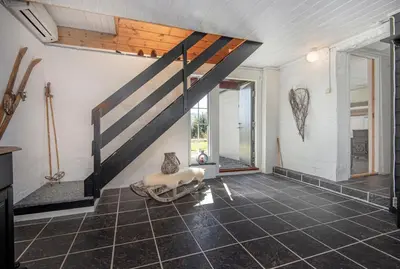 a living room with a staircase in a house at Økslevegen 2 in Stranda