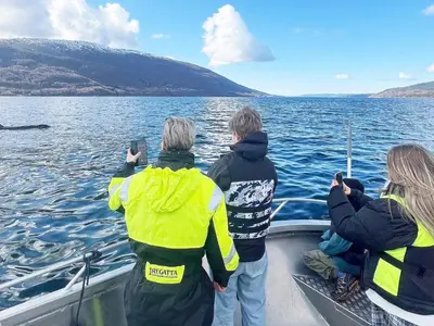 three people on a boat on a body of water at 7 person holiday home in Huglo-By Traum in Nordhuglo