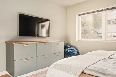 a bedroom with a dresser with a tv on it at Odda Panorama in Odda