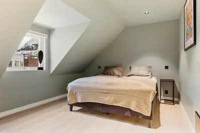 a bedroom with a bed in a attic at Odda Panorama in Odda
