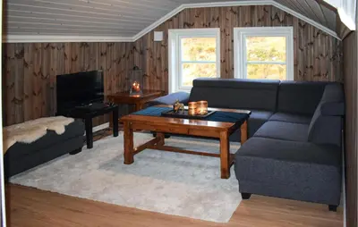 a living room with a couch and a coffee table at Lovely Home In Hjartdal With Sauna in Hjartdal