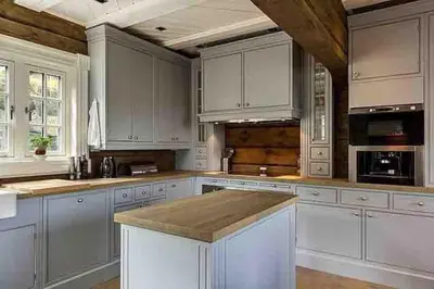 a large kitchen with white cabinets and a counter top at Stor og eksklusiv tømmerhytte Hemsedal in Grøndalen