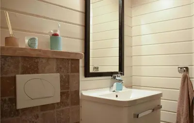 a bathroom with a sink and a mirror at Cozy Home In Norheimsund With Sauna in Norheimsund