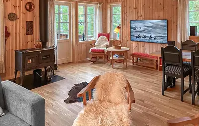 a living room with a dog sitting in a chair at 4 Bedroom Cozy Home In Straumgjerde in Brunstad
