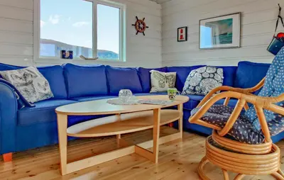 a blue couch with a table in a room at Pet Friendly Home In Roan in Moen