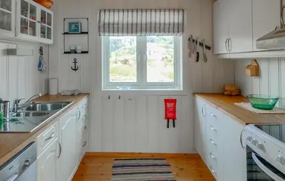 a kitchen with white cabinets and a window at Pet Friendly Home In Roan in Moen