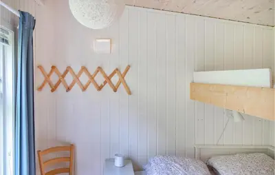 a bedroom with white walls and a bunk bed at 1 Bedroom Nice Home In Skånevik in Skånevik