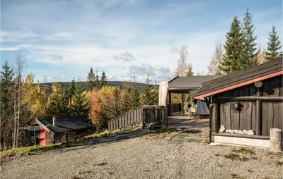 a home with a barn and a driveway at Stunning Home In Søre Osen in Midskogberget