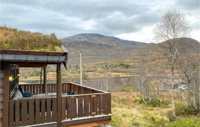 a porch of a house with a view of a mountain at Cozy Home In Straumgjerde With Sauna in Brunstad
