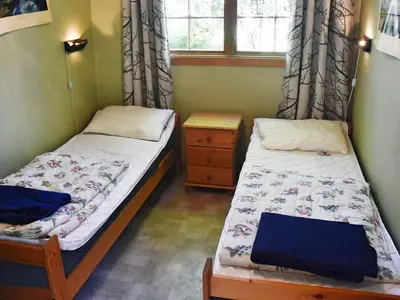 two twin beds in a room with a window at 4 person holiday home in Oldedalen-By Traum in Briksdalsbre
