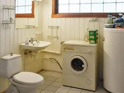 a bathroom with a washing machine and a sink at 4 person holiday home in Oldedalen-By Traum in Briksdalsbre