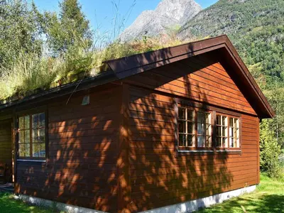 a small house with a grass roof and windows at 4 person holiday home in Oldedalen-By Traum in Briksdalsbre