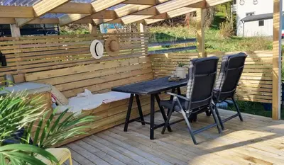a table and two chairs sitting on a patio at The Fjord House in Snofugl