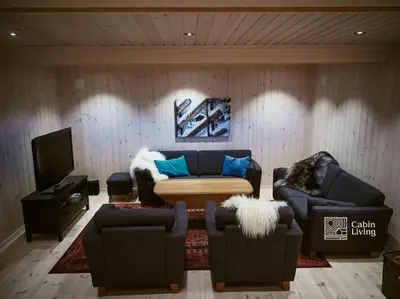 a living room with two couches and a tv at Large cabin at Nesfjellet with lovely view, inddor Jacuzzi & sauna in Nes i Ådal