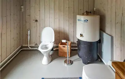a bathroom with a toilet and a water tank at 2 Bedroom Gorgeous Home In Eggedal in Eggedal